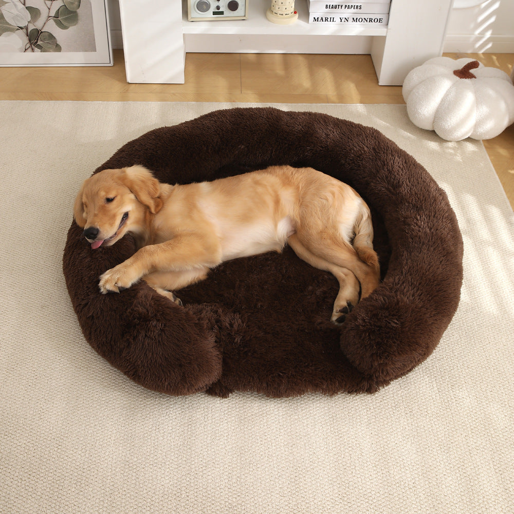 Golden Retriever sleeping in a round brown Kodi & Co. plush dog bed with raised walls on a light carpeted floor.