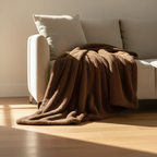 Kodi & Co. brown plush pet blanket draped over a beige sofa in a sunlit living room