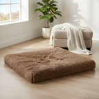 Kodi & Co. brown plush square pet bed with memory foam for deep sleep on a wooden floor in a bright living room